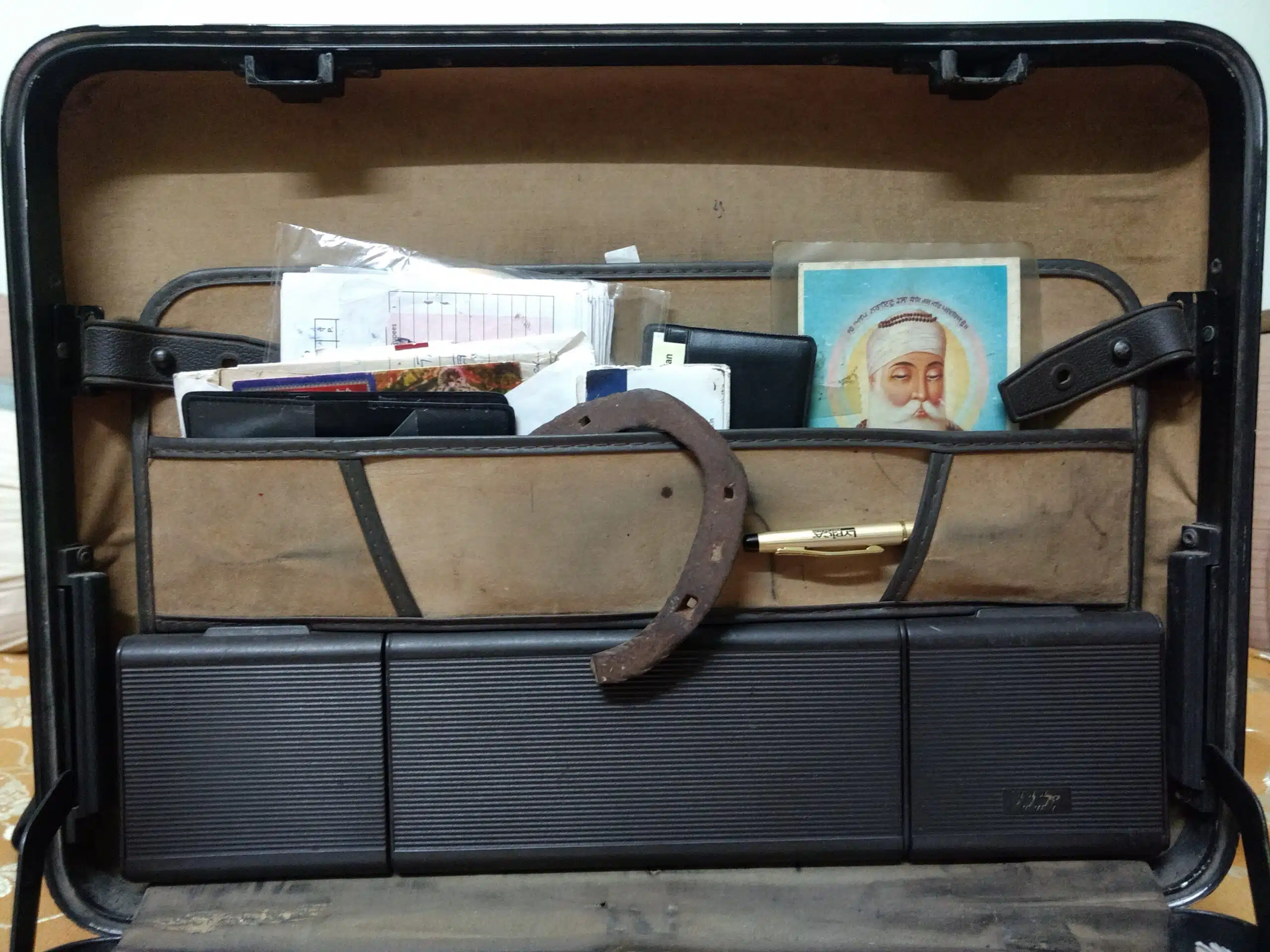 The horseshoe either hangs on a wall int he family's puja room or in Sanchita's uncle's old briefcase.