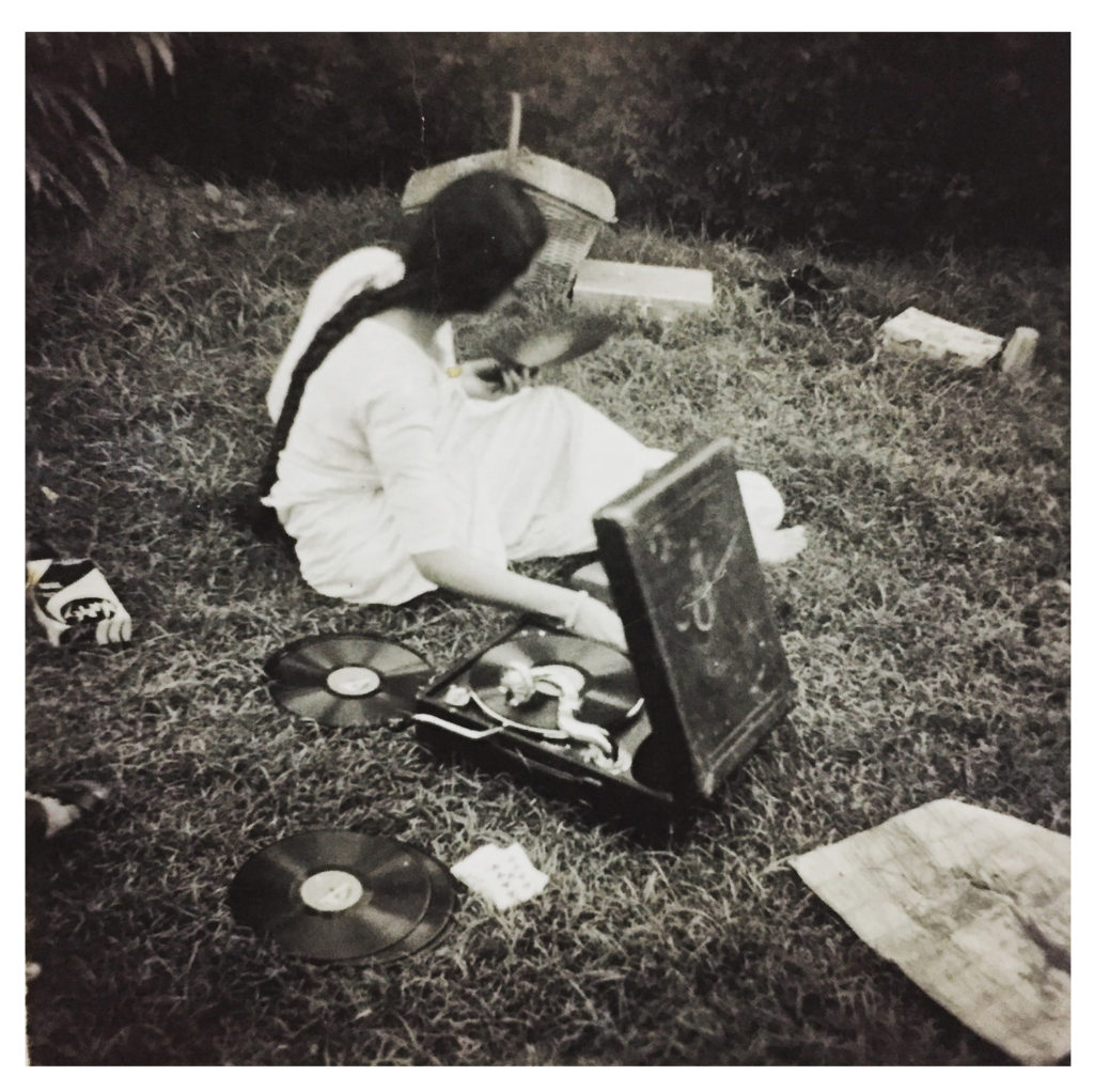 A photograph of Vimla Jain, with their gramophone at one of the picnics