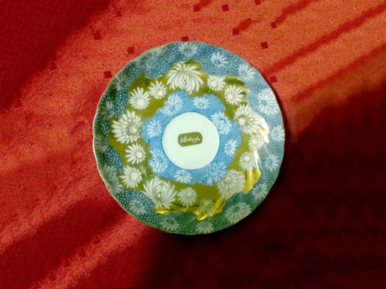 A saucer with the name Haji Jan Mohammed inscribed in gold lettering